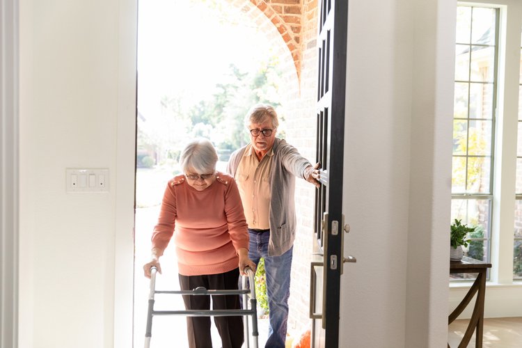Senior Couple Entering Home, Assistance and Support